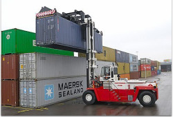 Loaded container handler with top-lift spreader